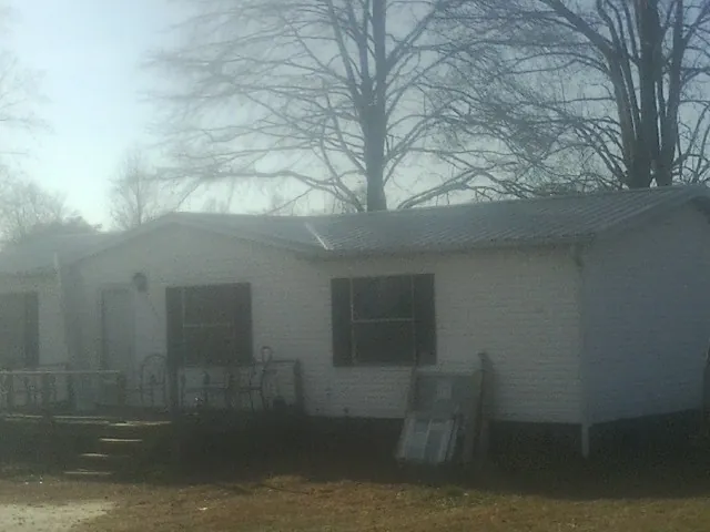 New metal roof on a white painted brick home on a foggy morning in Yorklyn