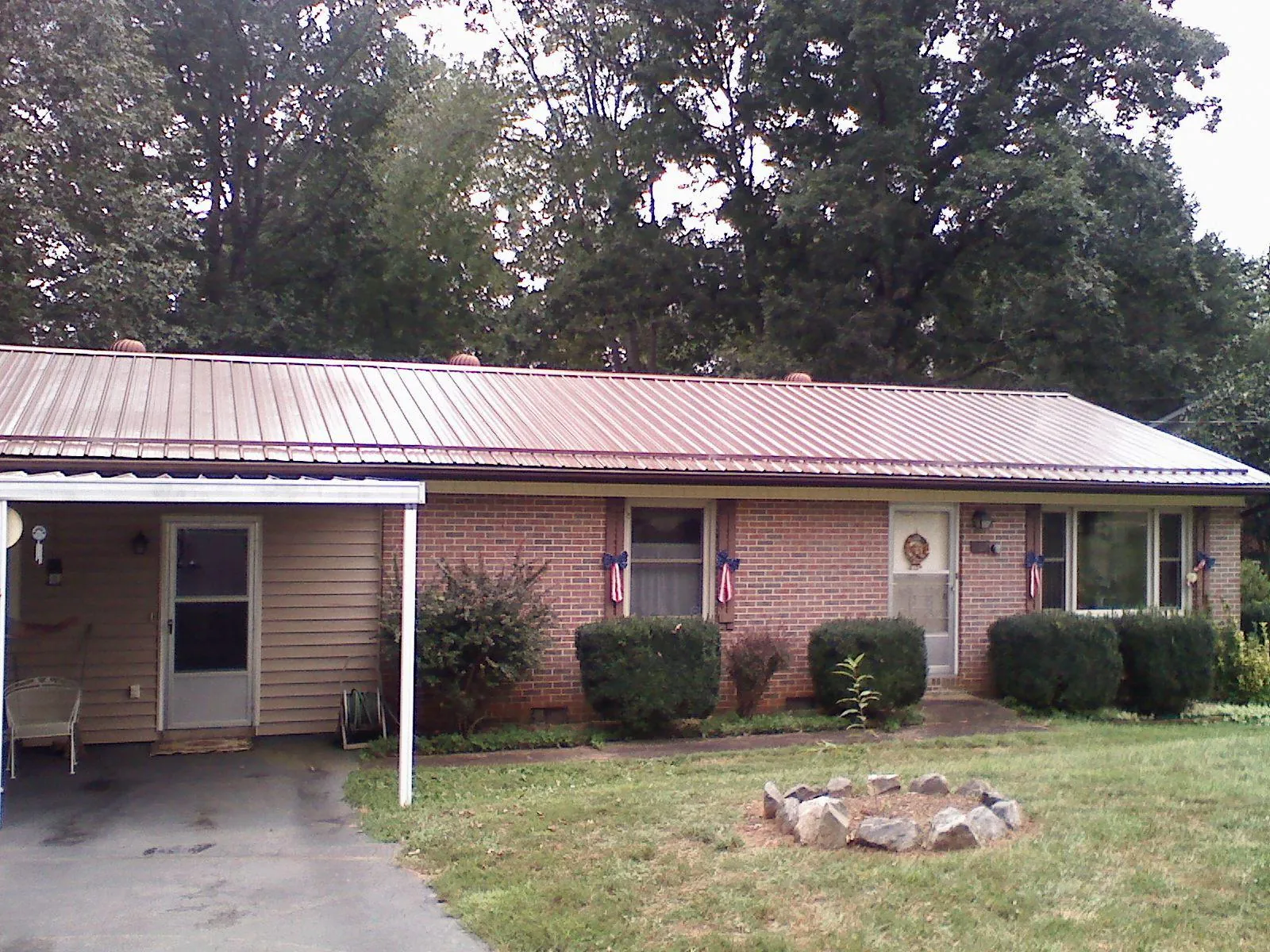 Bronze metal roof and carport on a brick ranch home — Roof Repair work by our crew in Yorklyn